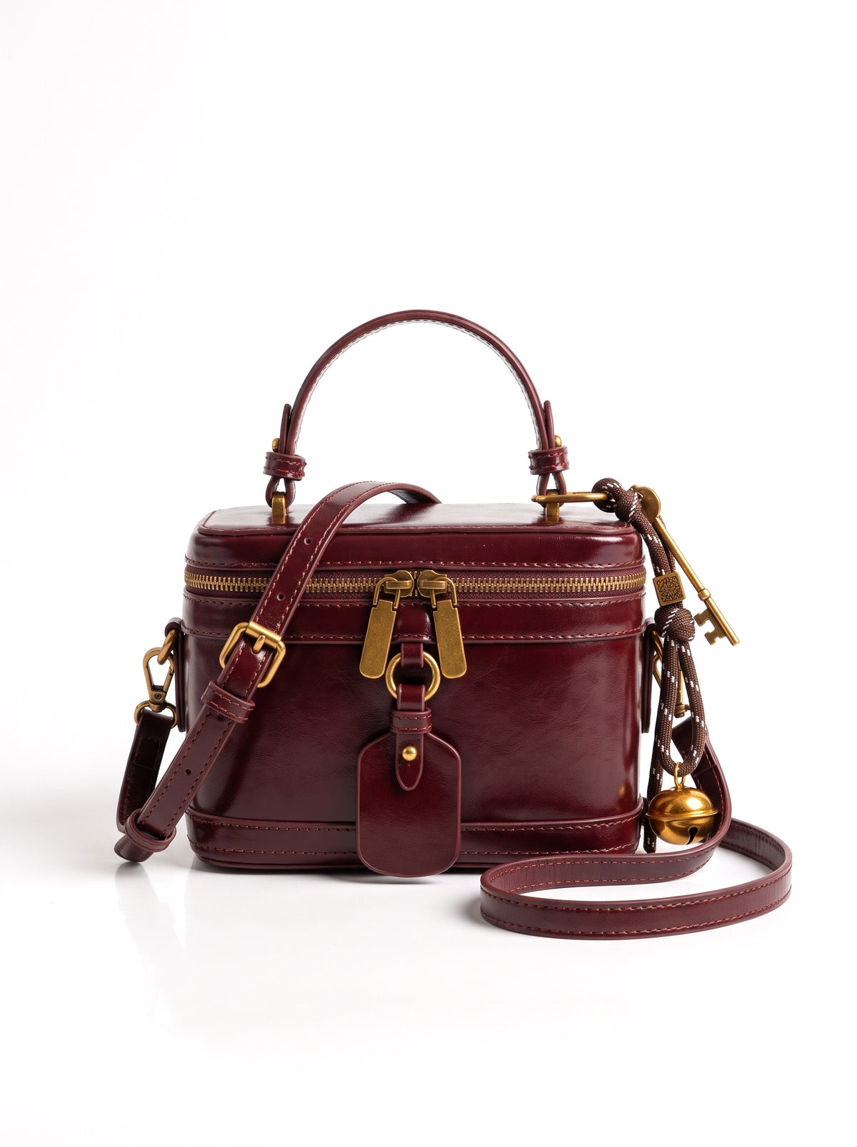Bolso neceser de piel con asa en burdeos, fondo blanco